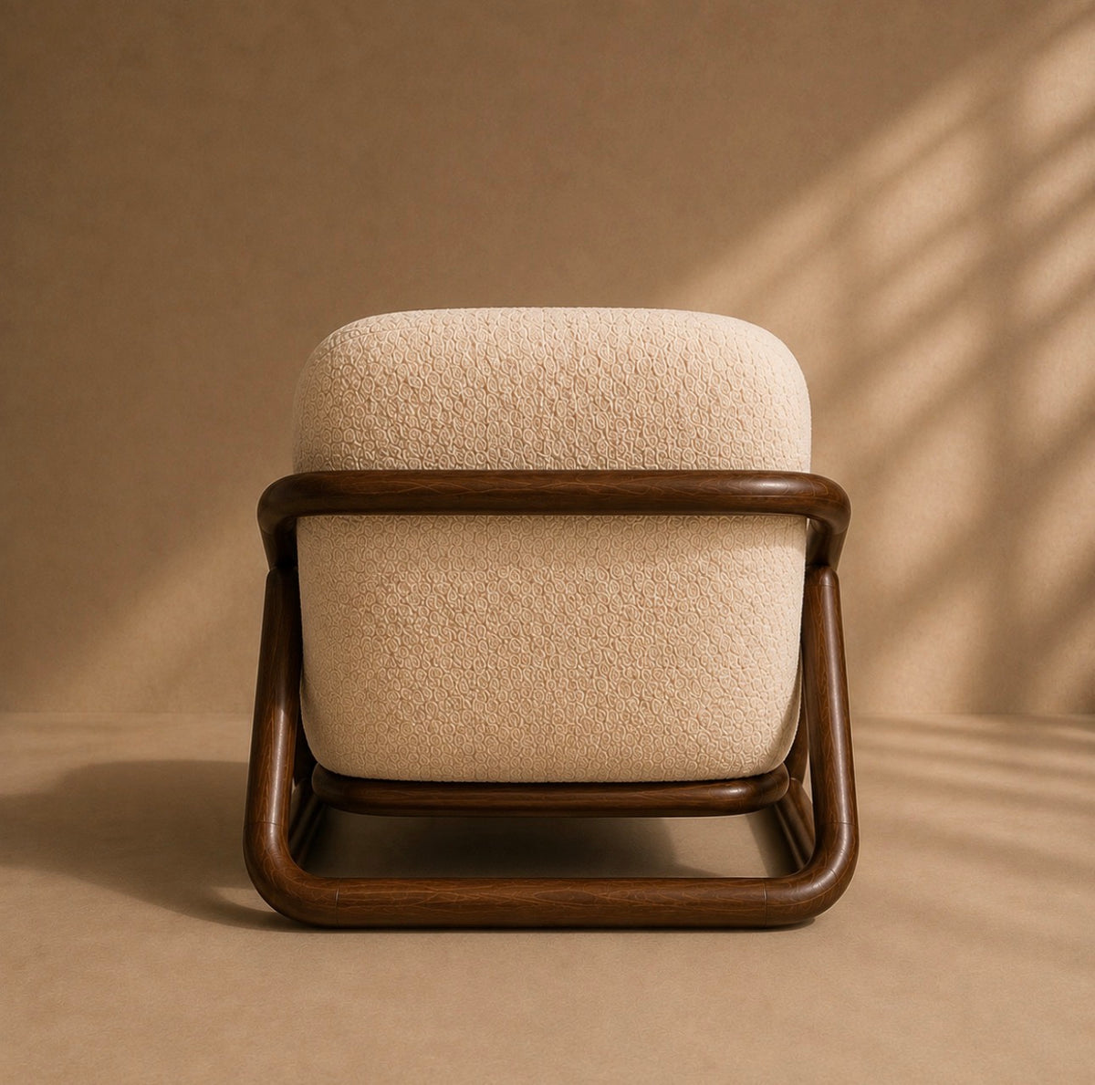 Montu lounge chair from behind, showing the open frame wrapping the upholstered back