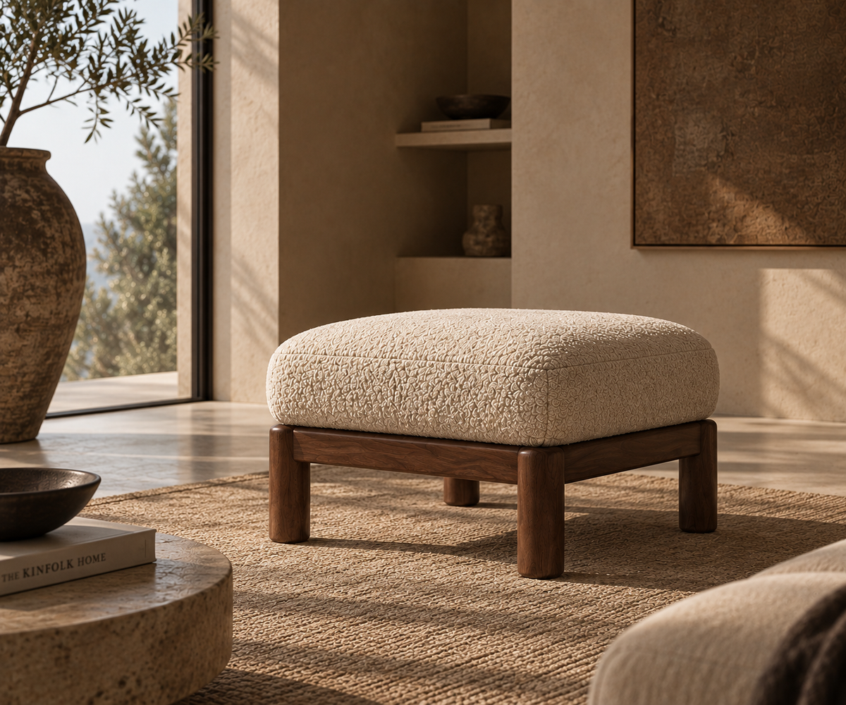 Hapi ottoman on a woven rug in a sunlit room
