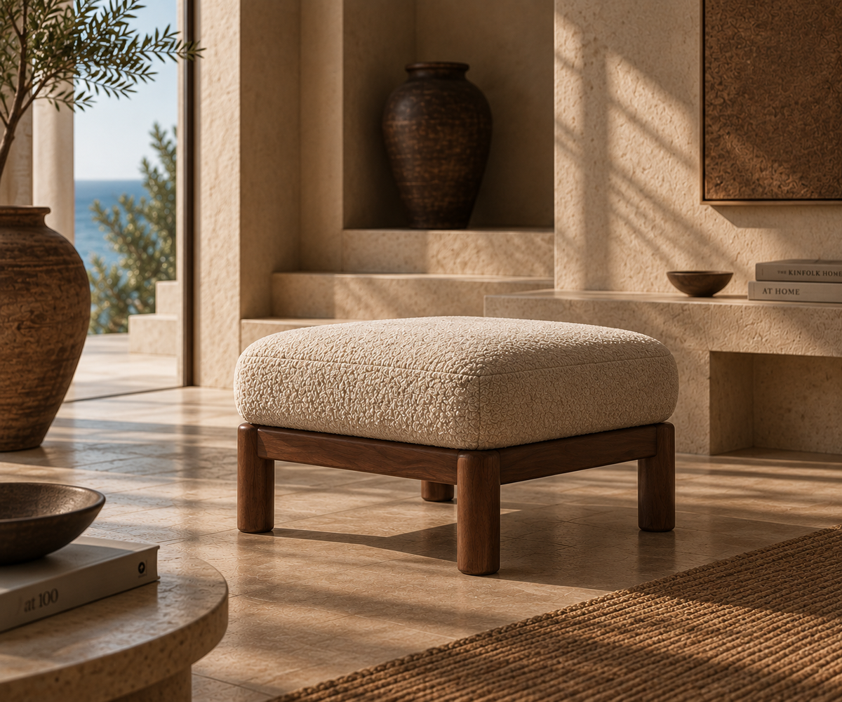 Hapi ottoman at a three-quarter angle in a stone room, with the sea beyond